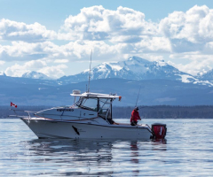 fishing-boat-mountains-background